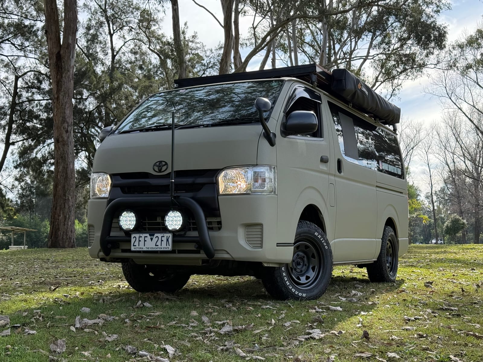 Khaki 4&times;4 Hiace &mdash; Front three-quarter, bullbar and spotlights