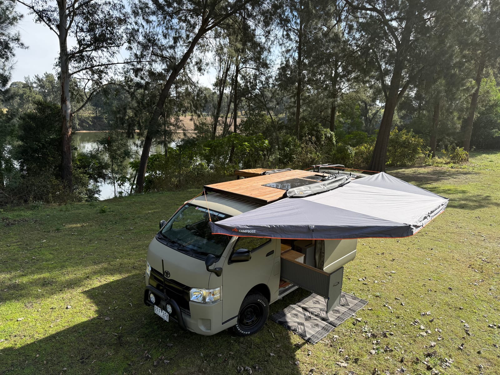 Khaki 4&times;4 Hiace &mdash; Set up beside the water