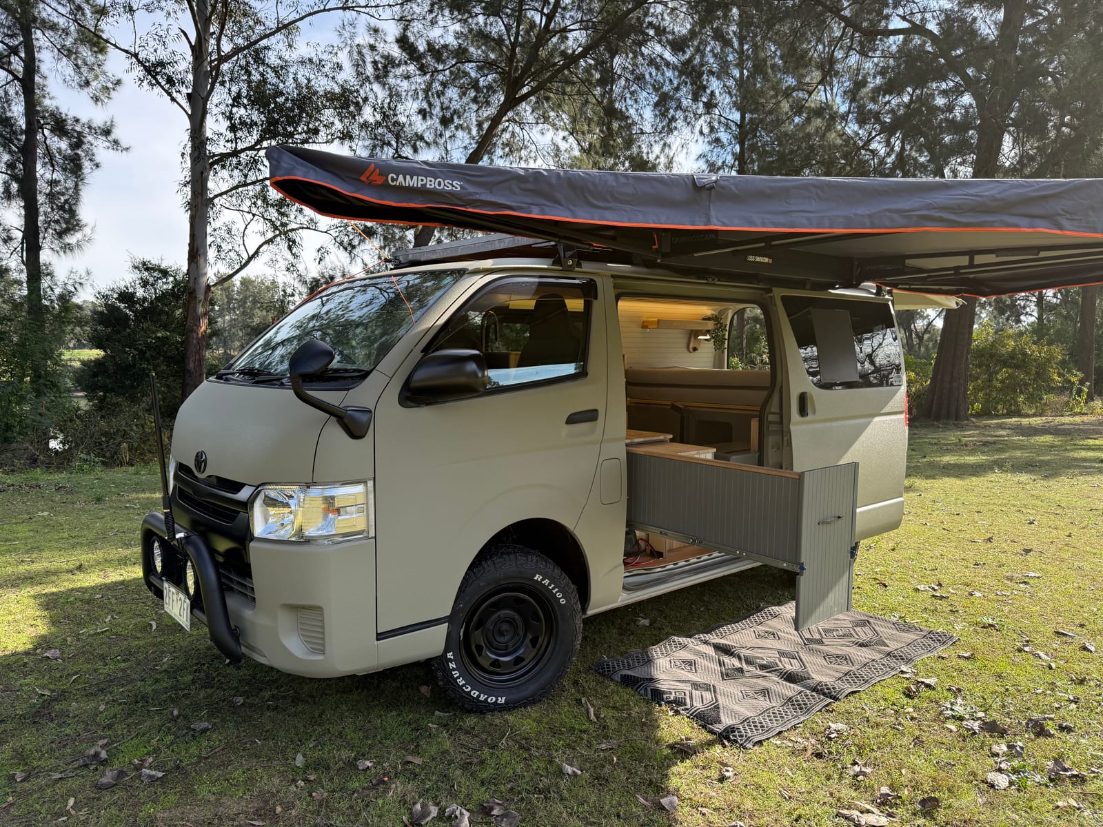 Khaki 4×4 Hiace — Side on, awning over the door