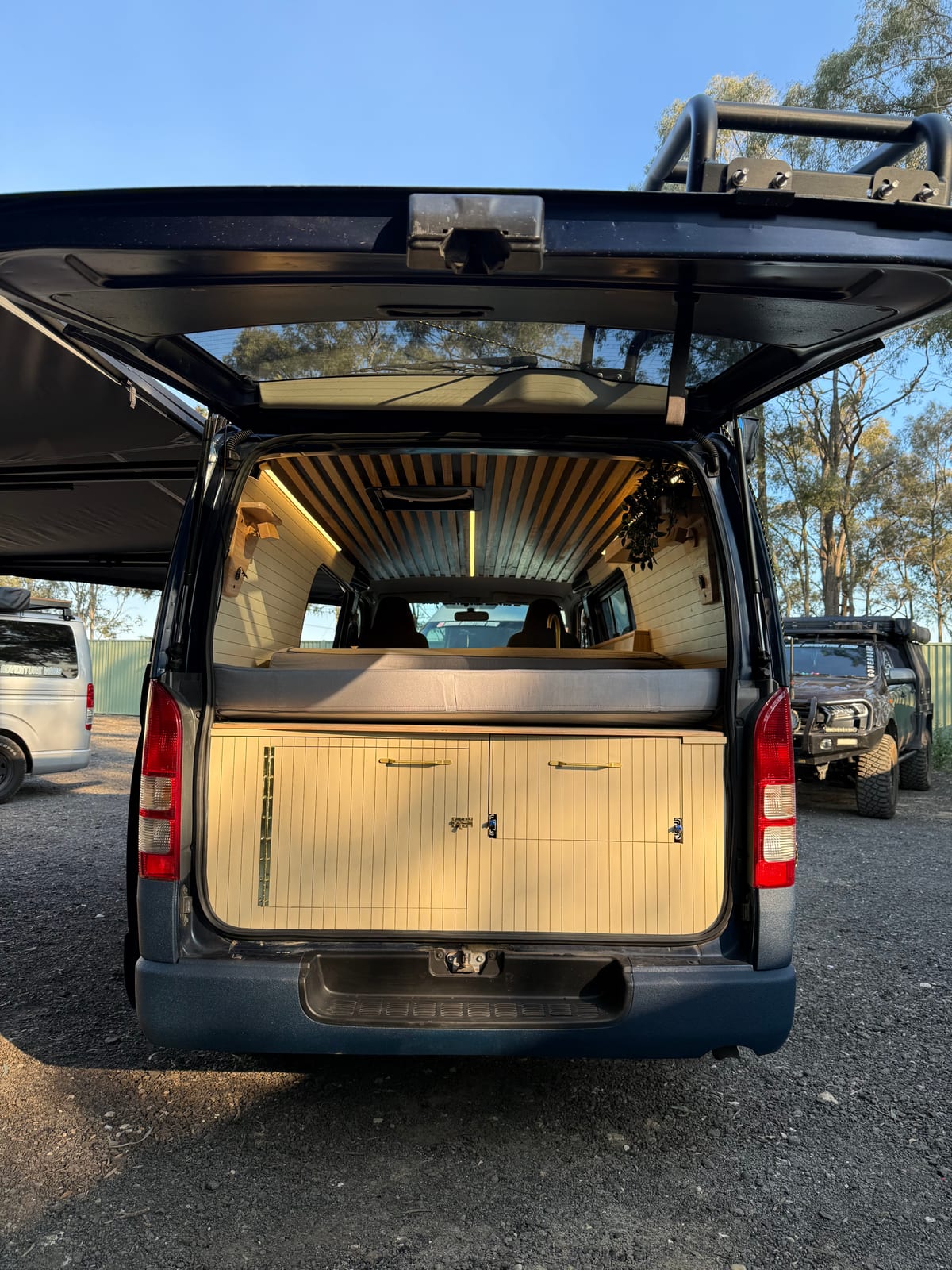Navy 4&times;4 Hiace &mdash; Rear doors open onto the bed