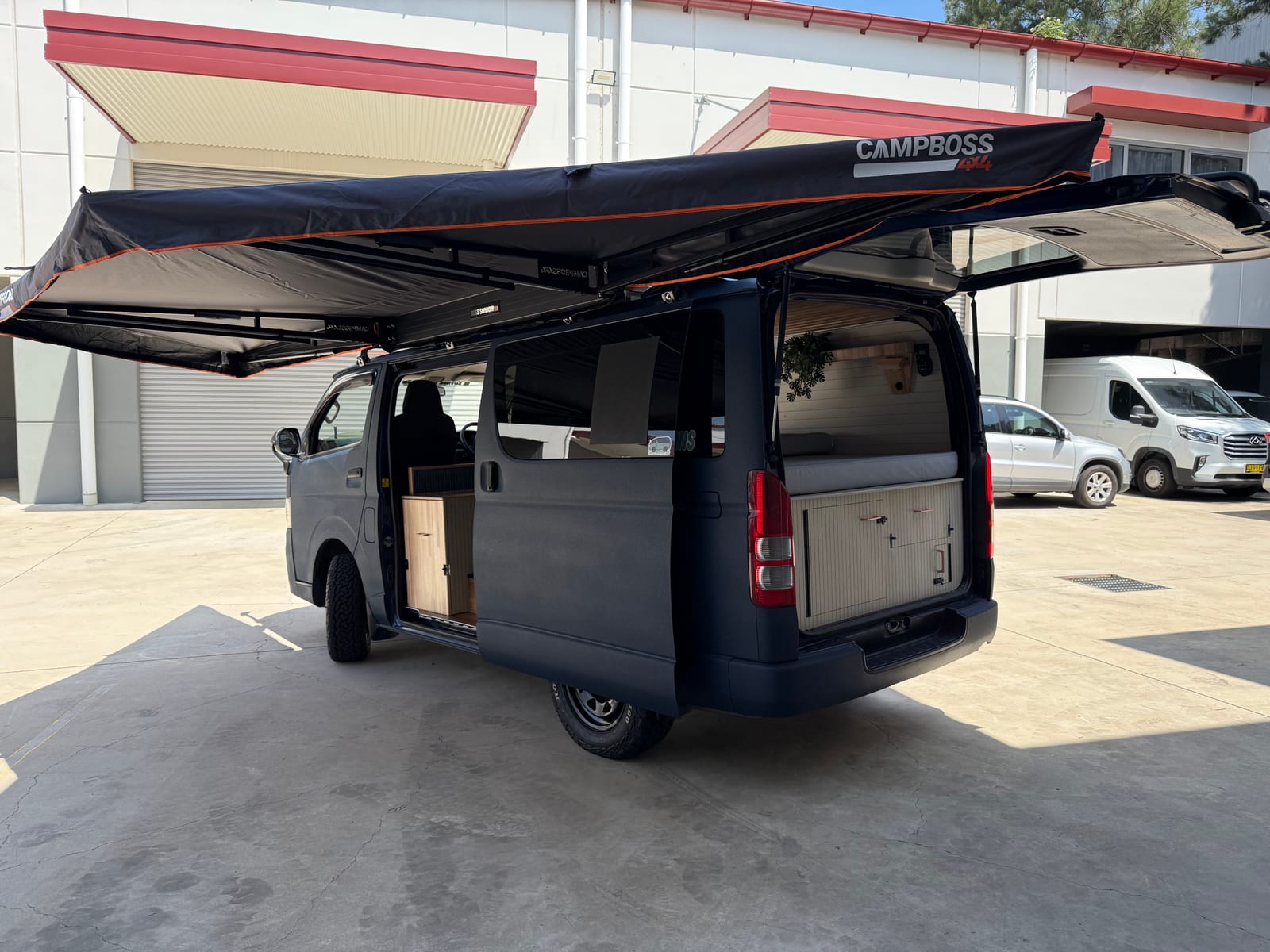 Slate Blue Hiace &mdash; Rear quarter under the awning