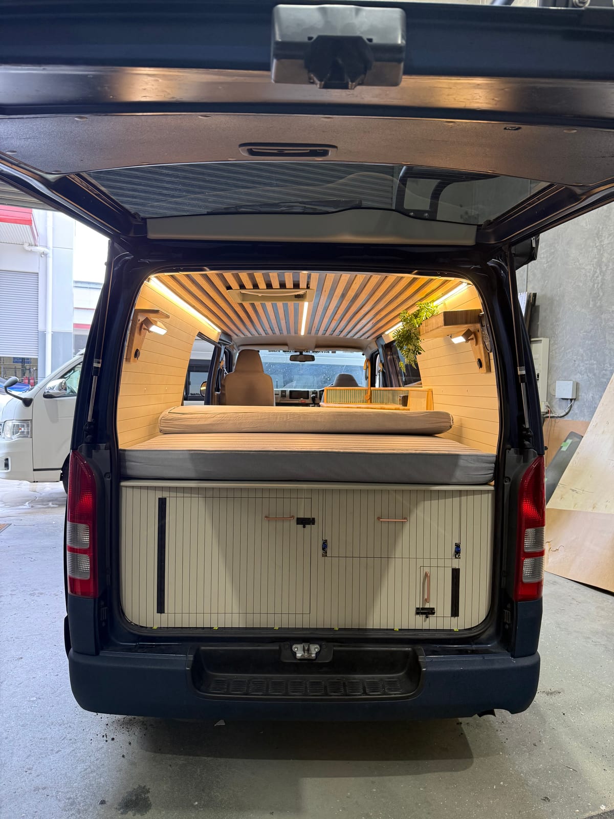 Slate Blue Hiace — Rear doors open onto the bed