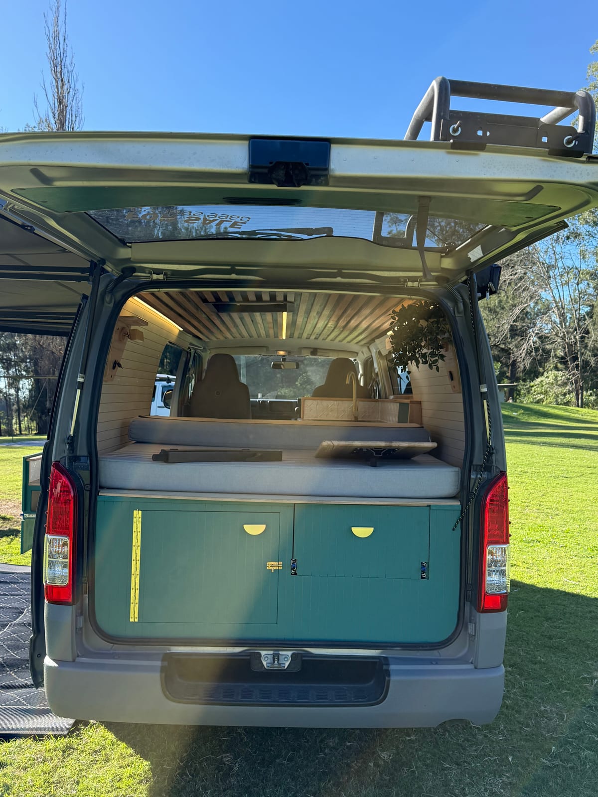 Teal Galley Hiace &mdash; Rear doors open onto the bed