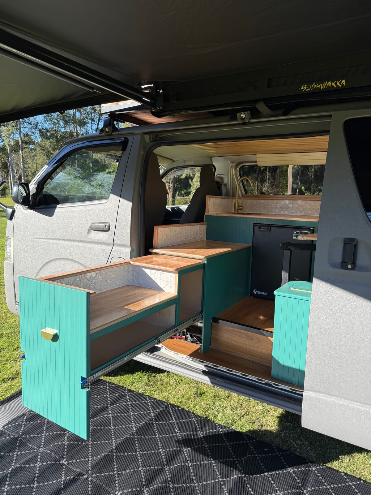 Teal Galley Hiace — Teal doors open through the side